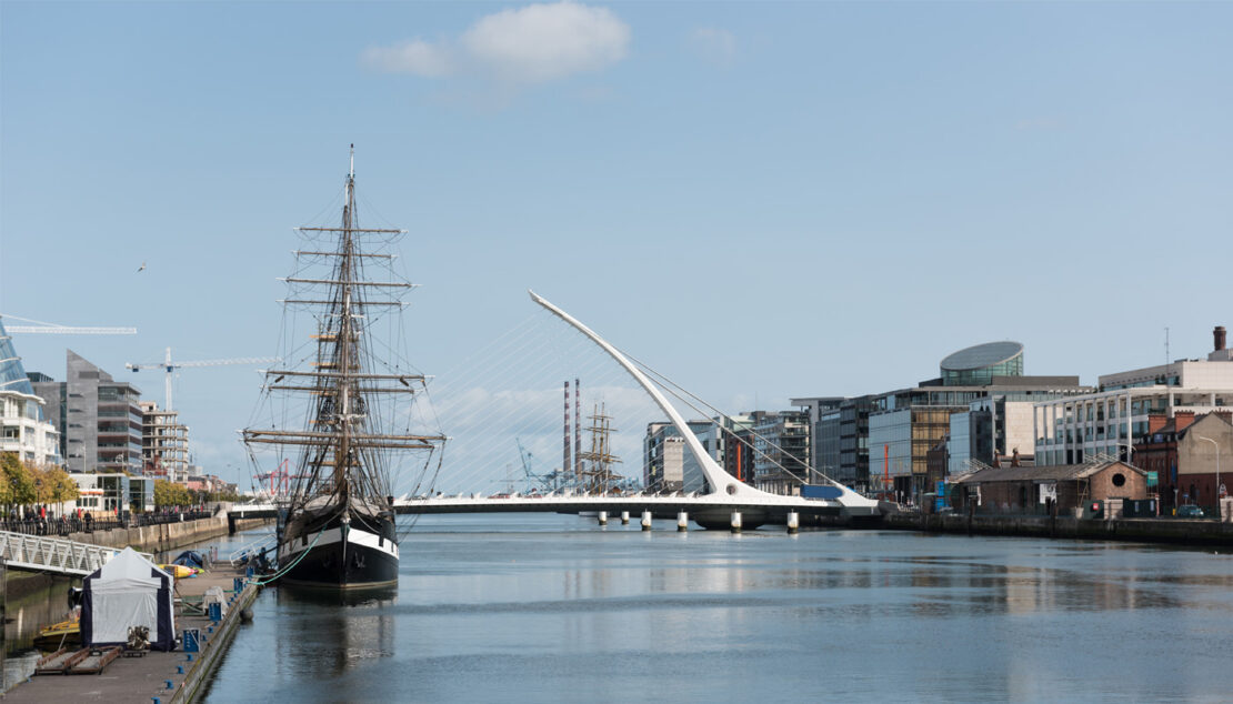 The river Liffey in Dublin with Samuel Becket Bridge and a square rigger sailing boat